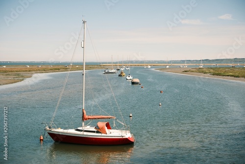 Konstfotografi Red Sailing Yacht Moored in a Calm Tidal Harbour on the English Coast