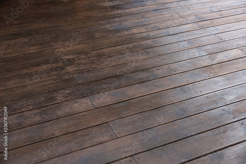Schilderij op canvas Indoor close up of weathered wooden boards laid lengthwise, seams and knots visi