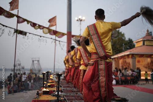 Bild auf Leinwand Morning Ganga aarti rituals performed by unrecognized Hindu priests at Assi Ghat in Varanasi with selective focus