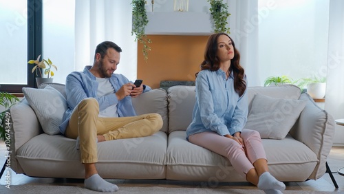Photography Annoyed dissatisfied Caucasian woman offended sitting near man busy with mobile phone gadget addict laughing watching humorous video laugh smartphone dependency