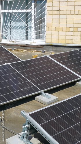 The Concept of Green Energy in an Urban Environment. Solar panels on the roofs of old apartment buildings. A rooftop solar power plant - Vetical video