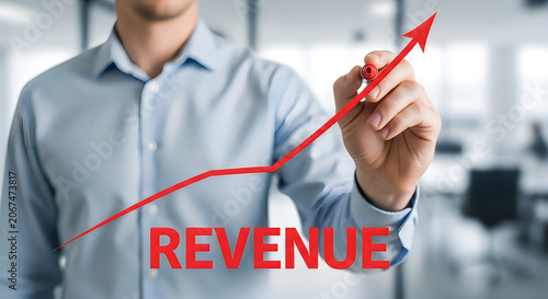 Businessman drawing revenue graph on graph