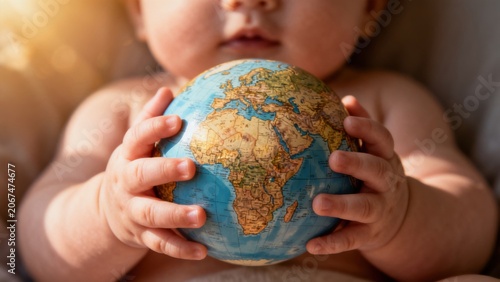Baby holding globe