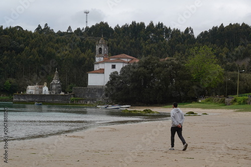 Historic Church of Nuestra Senora de los Dolores in Niembro estuary, vintage style with empty space for Asturias travel design and scenic tourism in Spain