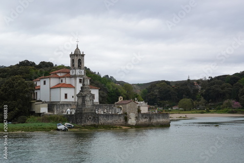 Historic Church of Nuestra Senora de los Dolores in Niembro estuary, vintage style with empty space for Asturias travel design and scenic tourism in Spain