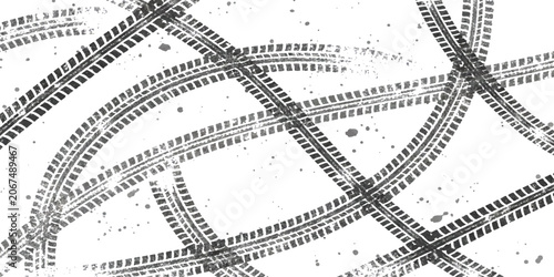 фотографія Black tire tracks pattern with multiple crossing marks on the ground