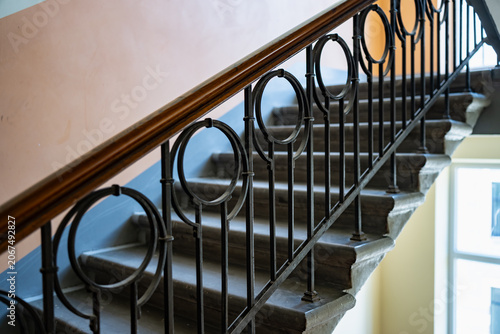 Εκτύπωση καμβά An elegant building entrance staircase framed by an antique iron safety banister