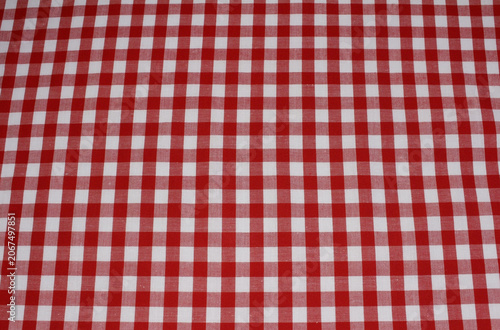 Texture of red and white gingham cotton cloth background. Close up of classic red plaid fabric.