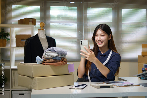 Quadro su tela Asian woman entrepreneur talking camera live recording video on social network at home