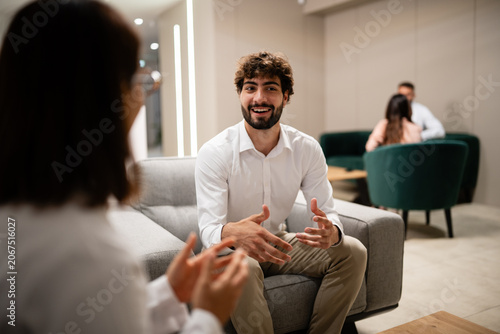 Professional man discussing business with female colleague
