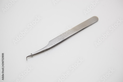 tools for eyelash extension and eyebrow design. cosmetic tweezers in silver color on a white background