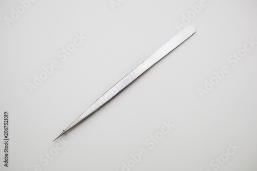 tools for eyelash extension and eyebrow design. cosmetic tweezers in silver color on a white background