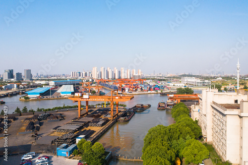 Grand Canal Port Terminal with Industrial Cranes and Shipping Containers