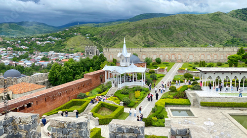 Landscaped gardens inside historic fortress complex. Elevated view across Rabat Fortress in Akhaltsikhe, Georgia with decorative pavilions, geometric hedges, stone architecture and visitors, cultural