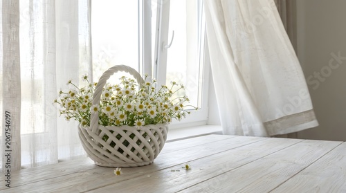 Bright Sunlit Windowsill with White Basket Filled with Fresh Daisies