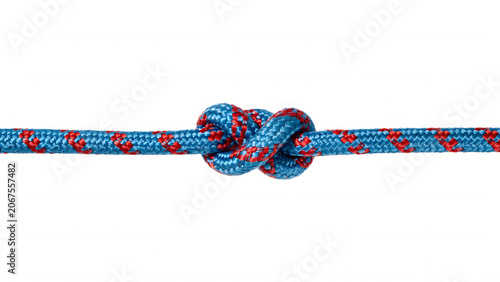 A single overhand knot tied in a blue and red braided climbing rope