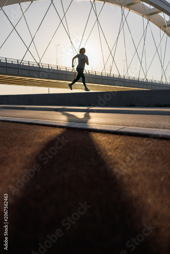 Fit woman jogging at dawn