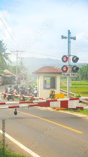 Rural Railroad Crossing with Signal Lights and Barriers.