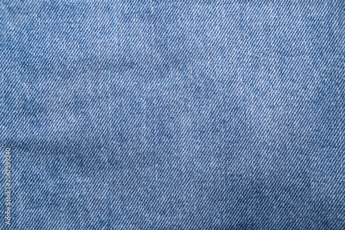 The denim is light blue. Denim background.