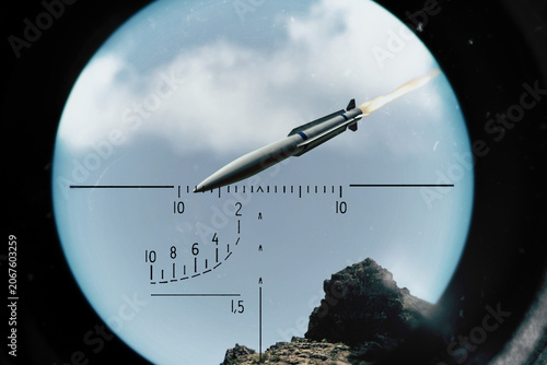 Fotografía A missile with flame trail flies in the sky and is tracked in a targeting system