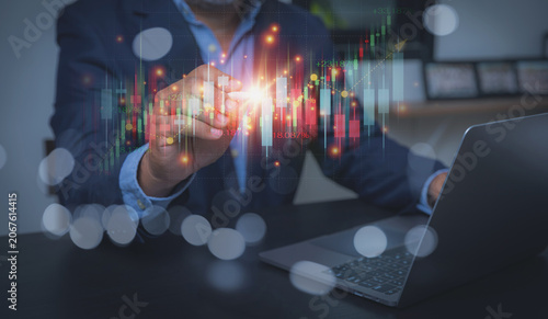 Businessman Using Stylus Pen to Analyze Stock Market Growth Chart on Laptop.