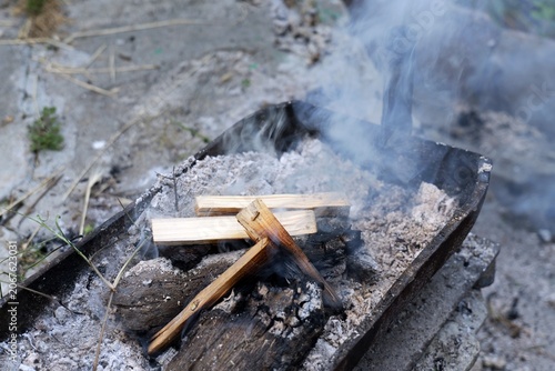 Fotografie Wood burning for barbecue with smoke and ashes