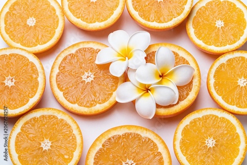A bunch of oranges with white flowers on top of them