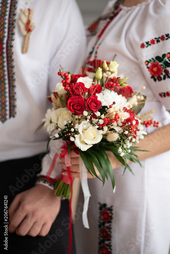 bride and groom in embroidered Ukrainian dresses. A beautiful bouquet