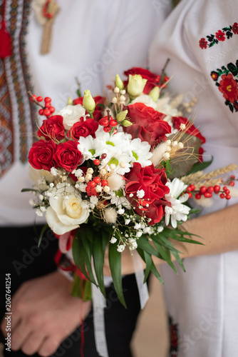 bride and groom in embroidered Ukrainian dresses. A beautiful bouquet