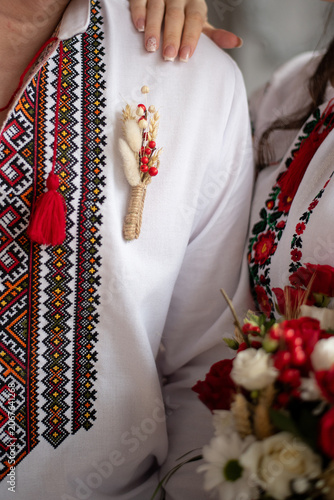 bride and groom in embroidered Ukrainian dresses. A beautiful bouquet