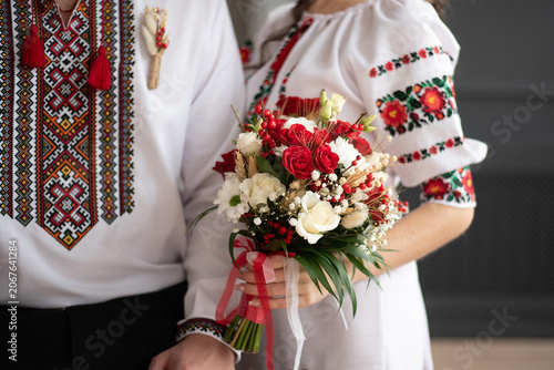 bride and groom in embroidered Ukrainian dresses. A beautiful bouquet