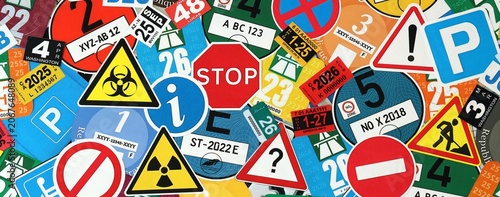 Pattern of traffic and road signs including warning symbols, Swiss and German vignettes