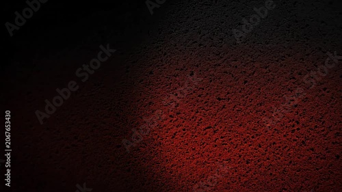 Rough Textured Surface Illuminated by Warm Reddish Glow in Dark Moody Environment