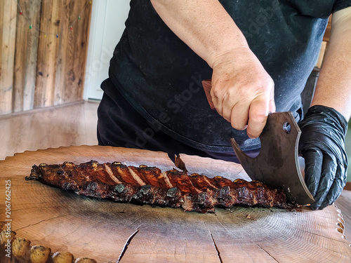 Slicing Grilled Ribs on a Wooden Board