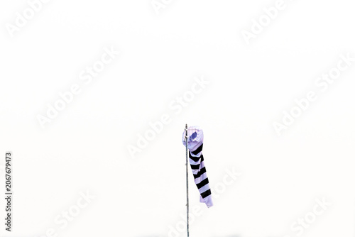 Black and white striped windsock used to indicate wind direction and speed.