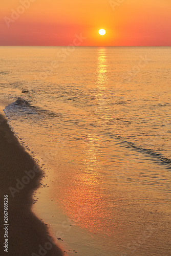 Sunrise Over Calm Ocean Waters