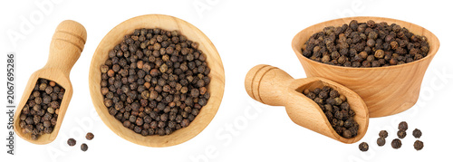 Black peppercorns or pepper in a wooden bowl isolated on a white background. Top view. Flat lay