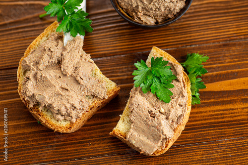 Top view of homemade pate sandwiches on brown wood