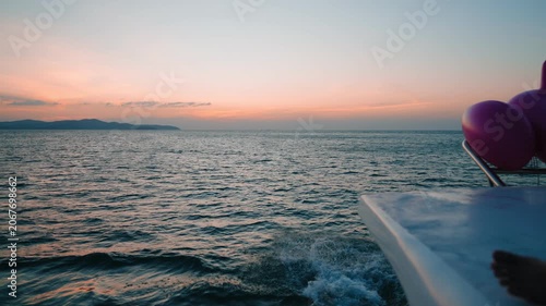 Silhouette of a man jumping from a yacht into the ocean during a beautiful sunset, representing freedom, adventure, luxury travel, summer vacation, active lifestyle, and successful living