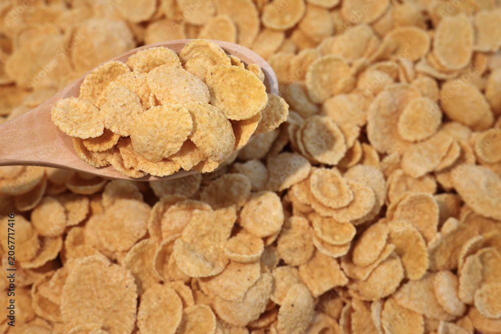 Fototapeta premium corn flakes - healthy breakfast cereal in wood spoon