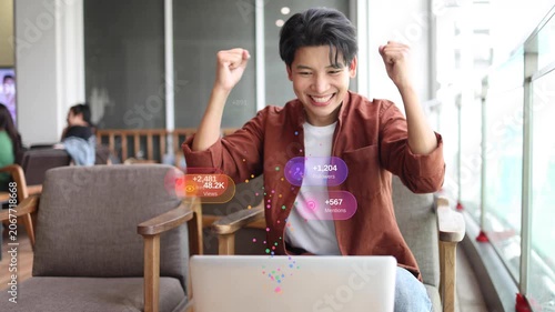 Happy young Asian man content creator smiling while working on a laptop at a cafe with floating social media notification icons like followers, views, and comments, digital marketing viral success