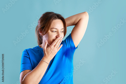 Obraz na plátne Woman noticing unpleasant underarm odor
