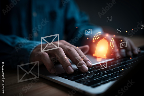 Tableau sur toile Email notification and alert concept on laptop computer with glowing bell icon and message symbols