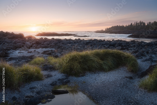 Sunset over a rocky Pacific beach with dune grass, Ucluelet, Vancouver Island