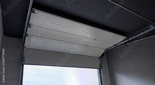 Fotografie Opened white automatic sectional garage door