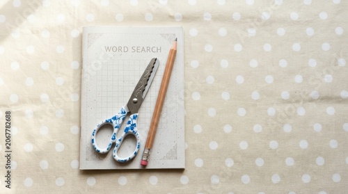 Stationery Set with Notebook Scissors and Pencil on Polka Dot Background.