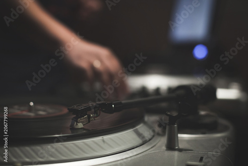 Night party with scratch dj playing vinyl