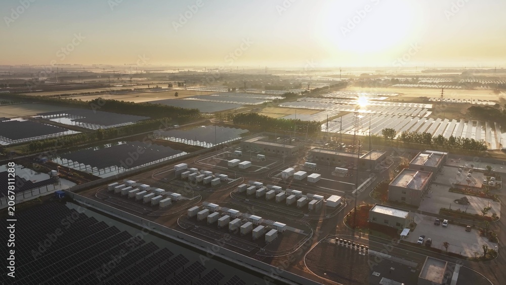 Fototapeta premium Solar photovoltaic power station and energy storage facilities under golden sunrise light