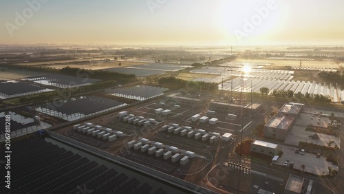 Solar photovoltaic power station and energy storage facilities under golden sunrise light