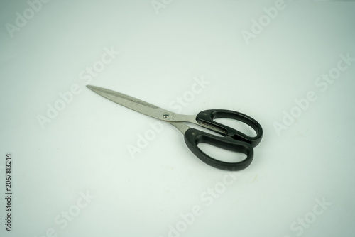 Silver and black scissors isolated on a clean white background